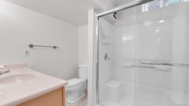 full bath featuring tile patterned flooring, a stall shower, toilet, and vanity