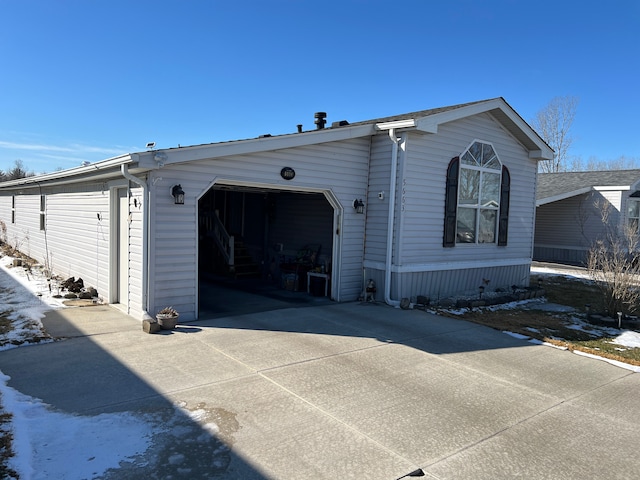 view of home's exterior with a garage and concrete driveway