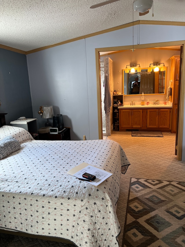 bedroom with a sink, ornamental molding, vaulted ceiling, a textured ceiling, and light colored carpet