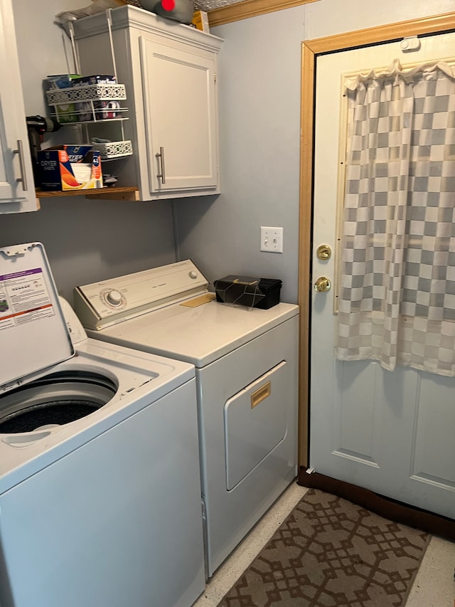 laundry room with cabinet space and washing machine and clothes dryer