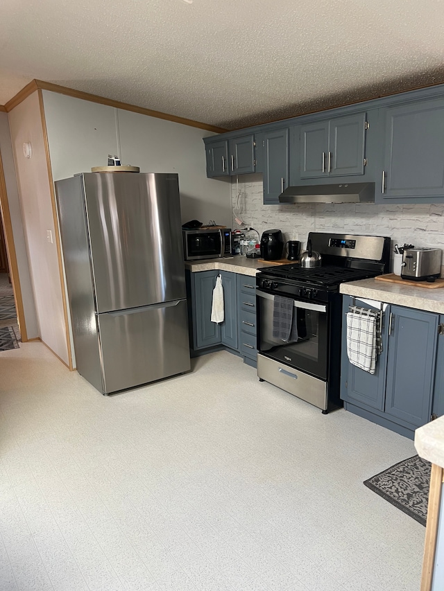 kitchen with light floors, ornamental molding, light countertops, under cabinet range hood, and appliances with stainless steel finishes