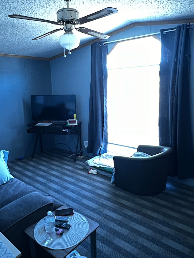 carpeted living room featuring a textured ceiling and ceiling fan