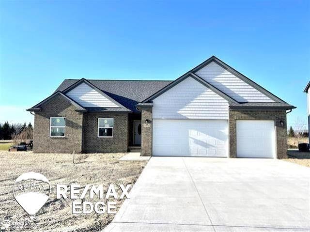 single story home featuring driveway and a garage