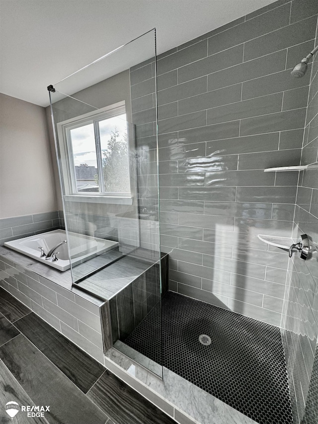 full bath featuring a walk in shower and a garden tub