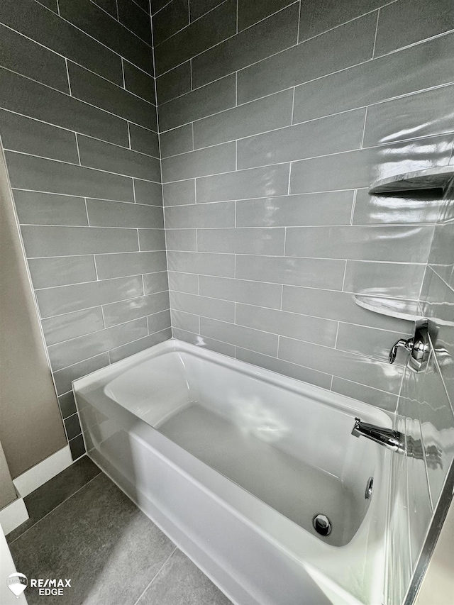 bathroom with tile patterned flooring and shower / tub combination