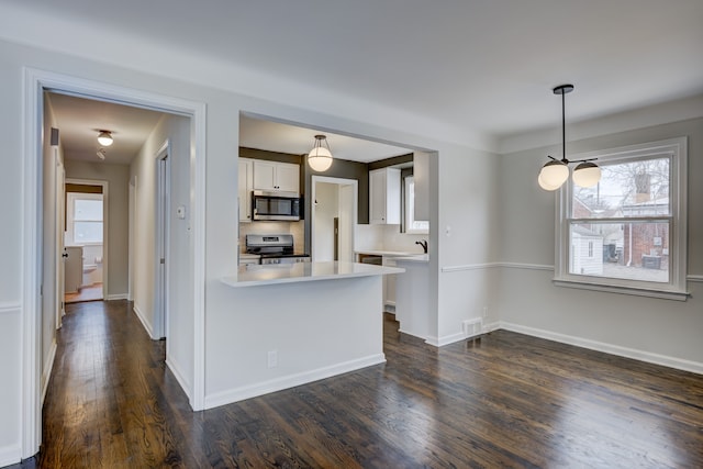 kitchen with visible vents, light countertops, appliances with stainless steel finishes, dark wood-style floors, and white cabinetry