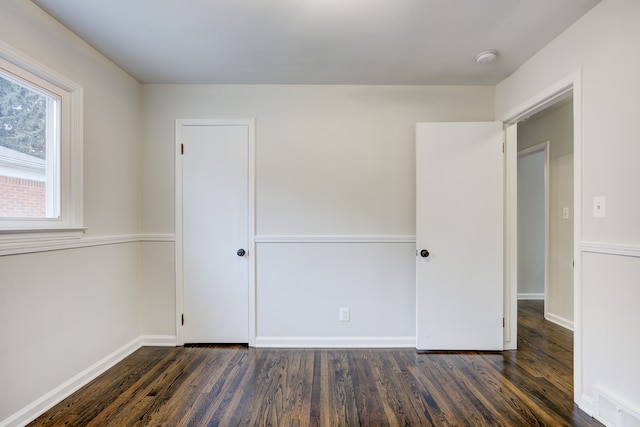 interior space with visible vents, baseboards, and wood finished floors