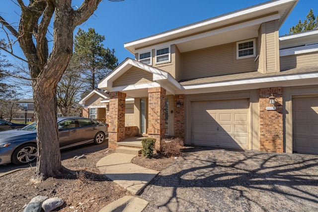 view of front of house featuring brick siding and an attached garage