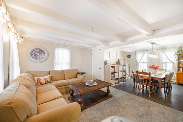 living room with stairway, a baseboard radiator, dark wood finished floors, beam ceiling, and a notable chandelier