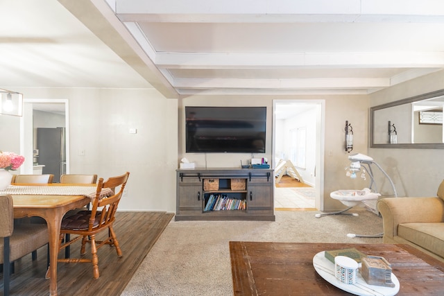 living room featuring beam ceiling and wood finished floors