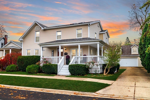 view of front facade featuring a detached garage, covered porch, an outdoor structure, and a front yard