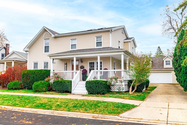 view of front of house with a porch, a detached garage, and an outdoor structure