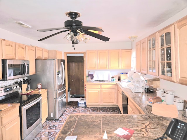 kitchen with visible vents, light brown cabinets, a ceiling fan, appliances with stainless steel finishes, and glass insert cabinets