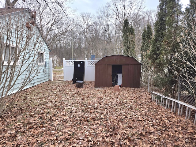 view of shed featuring fence