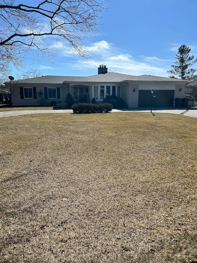 ranch-style home featuring a front lawn, concrete driveway, and a garage