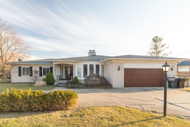 ranch-style house with a front lawn, driveway, a garage, brick siding, and a chimney