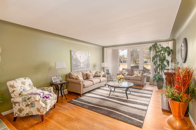 living room featuring wood finished floors and baseboards