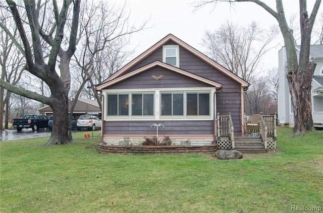 rear view of house featuring a lawn