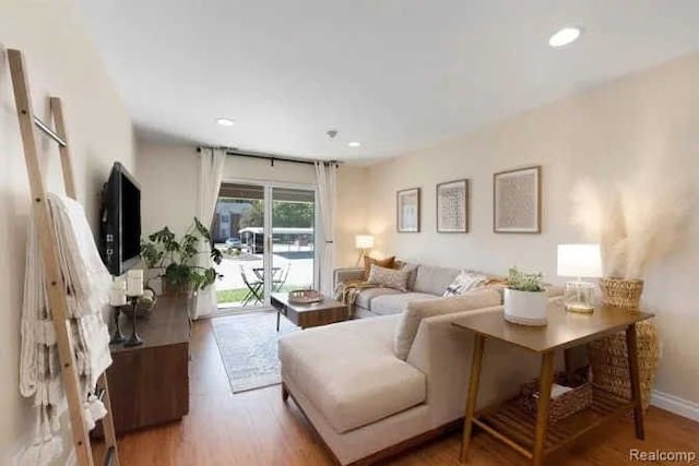 living area with recessed lighting, baseboards, and wood finished floors