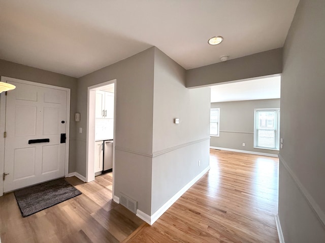 entryway with visible vents, baseboards, and light wood-style floors