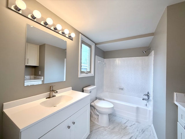 bathroom with marble finish floor, toilet, vanity, and  shower combination