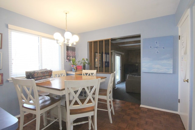 dining space with an inviting chandelier and baseboards