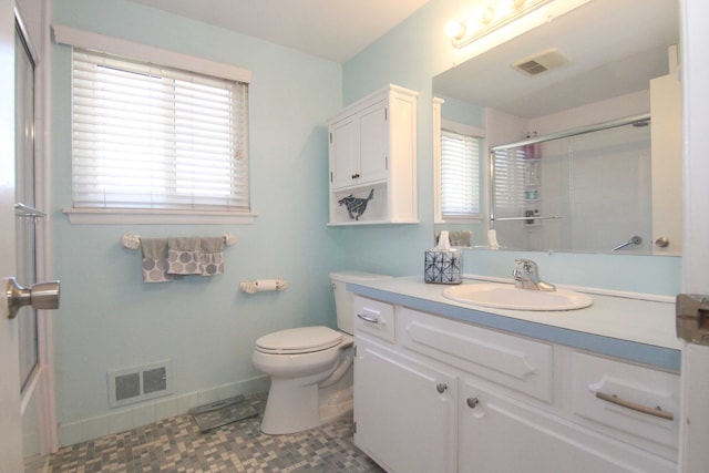 full bath featuring vanity, baseboards, visible vents, an enclosed shower, and toilet