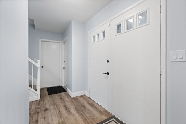 entrance foyer featuring baseboards and light wood finished floors