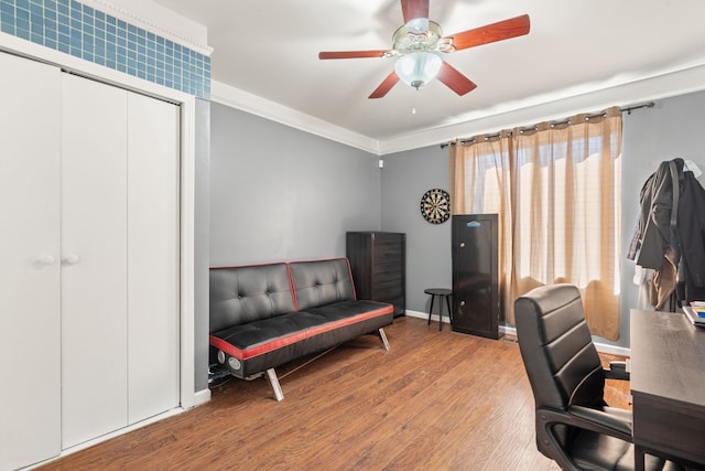 home office with ornamental molding, baseboards, ceiling fan, and wood finished floors