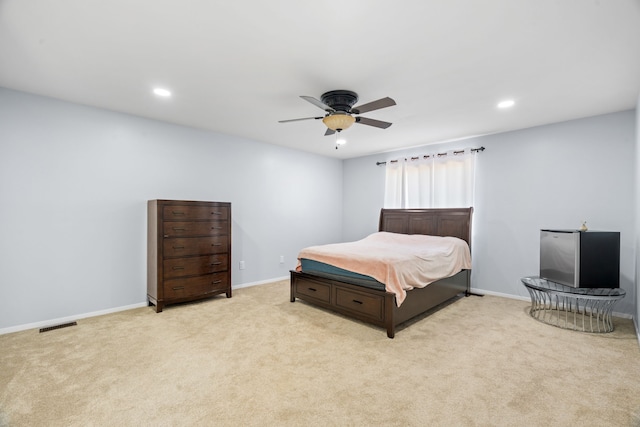 bedroom with recessed lighting, light colored carpet, and baseboards