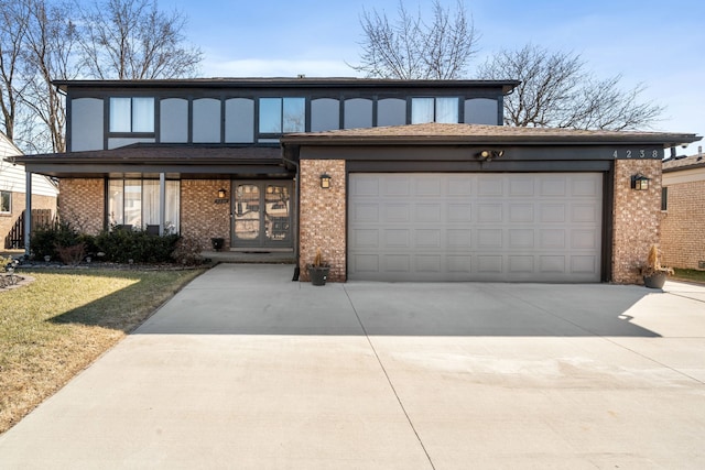 view of front facade featuring a front lawn, driveway, french doors, an attached garage, and brick siding