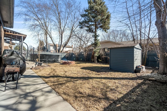 view of yard with an outbuilding, a storage shed, and a fenced backyard
