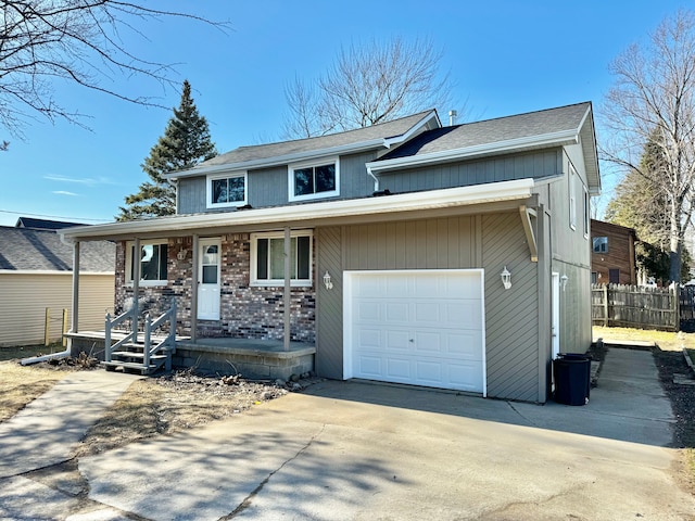 view of front facade with brick siding, a porch, concrete driveway, and fence