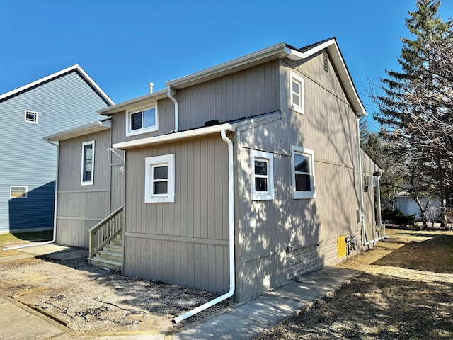 back of property featuring entry steps