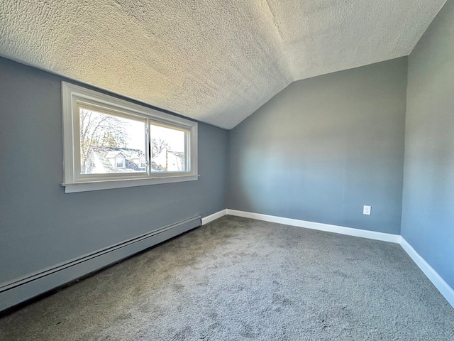 additional living space featuring baseboards, a baseboard radiator, lofted ceiling, a textured ceiling, and carpet flooring