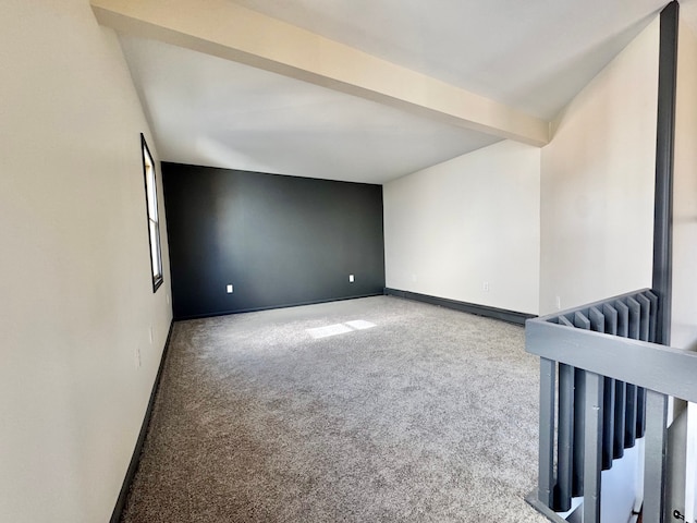 carpeted empty room featuring baseboards, beam ceiling, and radiator heating unit