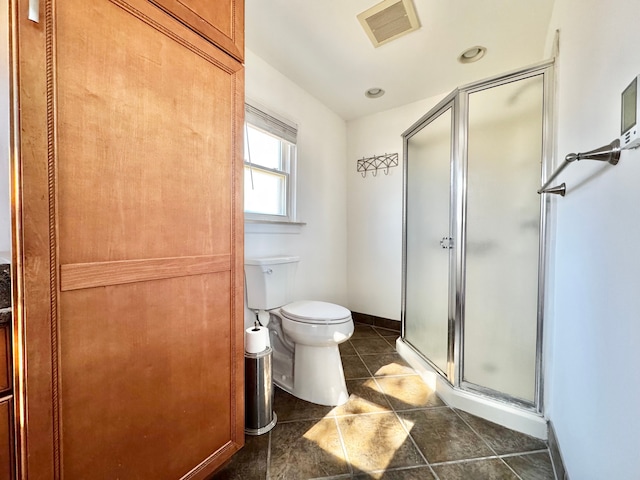 bathroom featuring visible vents, a shower stall, baseboards, toilet, and tile patterned floors