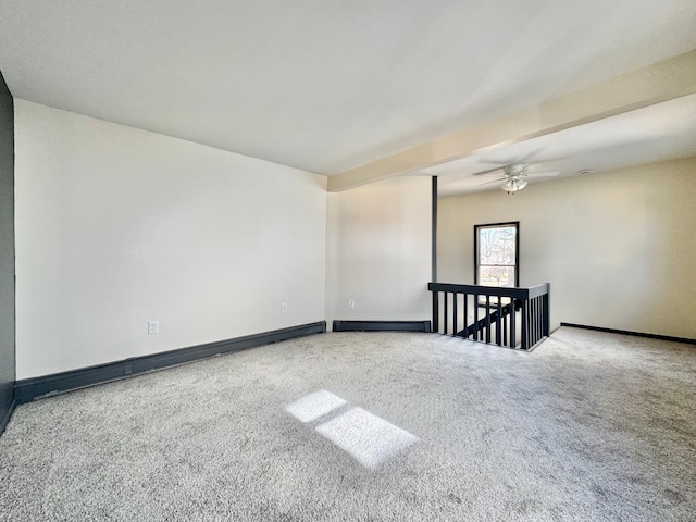 spare room featuring carpet flooring, ceiling fan, baseboards, and a baseboard radiator