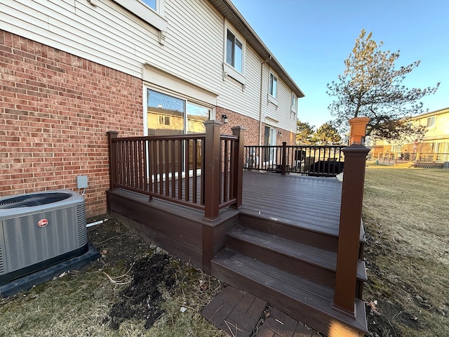 deck featuring a lawn and central AC