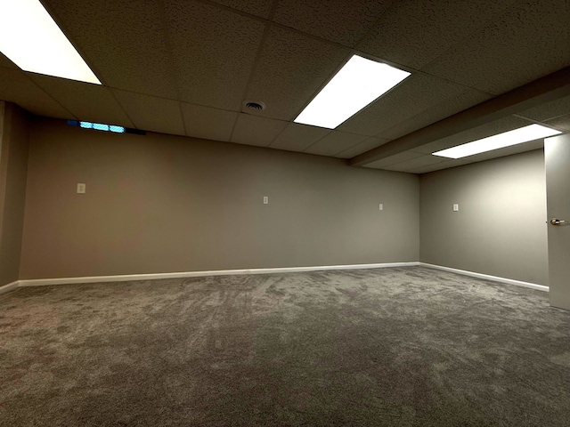 interior space with visible vents, carpet flooring, a paneled ceiling, and baseboards