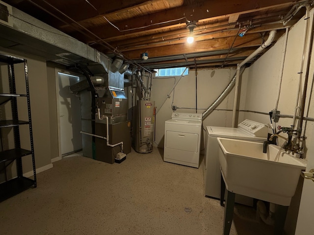 basement with a sink, heating unit, separate washer and dryer, and water heater