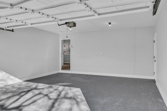 garage with a garage door opener and baseboards