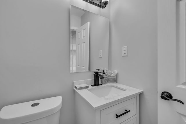 half bath with vanity and toilet