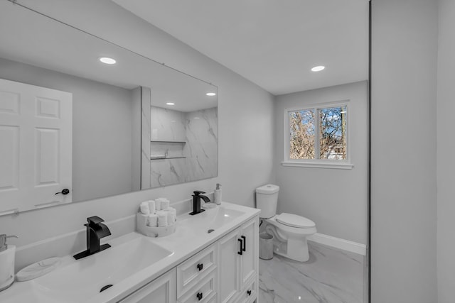 full bathroom featuring marble finish floor, toilet, baseboards, and a sink