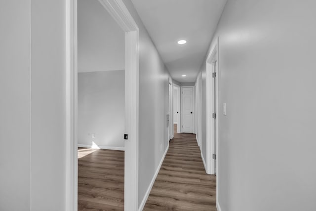 hall with recessed lighting, baseboards, and wood finished floors