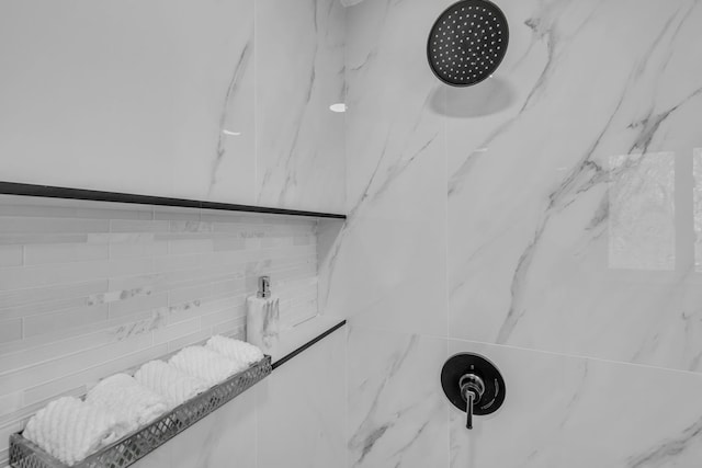 details featuring a marble finish shower