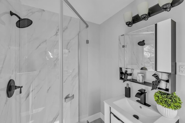 full bath featuring vanity and a marble finish shower