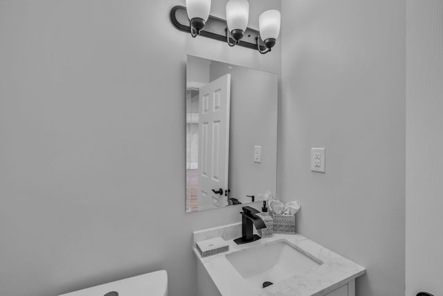 half bath featuring toilet and vanity