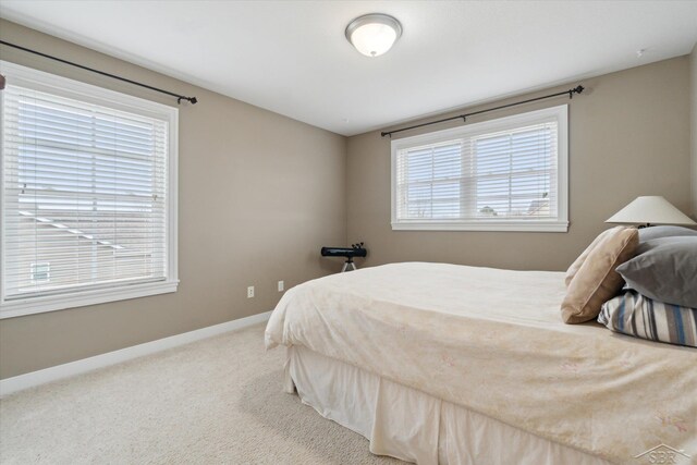 carpeted bedroom featuring baseboards