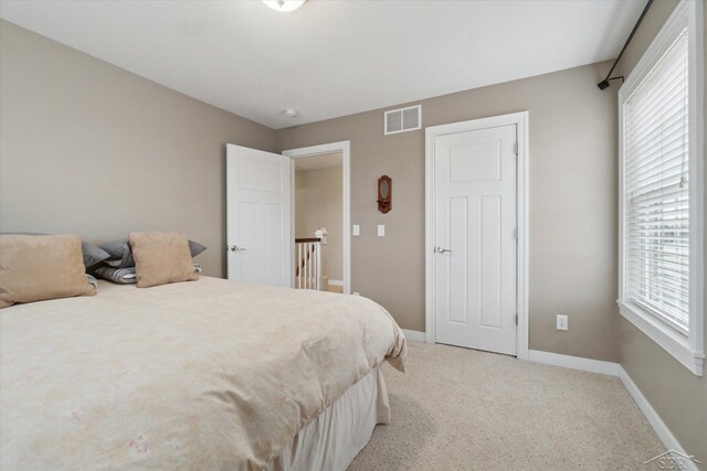 bedroom with visible vents, multiple windows, and baseboards